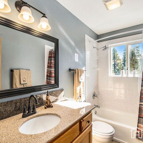 - unwind in a tranquil bathroom with a tub and shower combo framed by mountain views
- granite vanity and wood cabinetry bring rustic elegance to your routine
- warm lighting and calm tones provide a refreshing start or end to the day