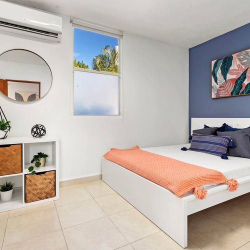 Find tranquility in this modern bedroom. The stylish teal accent wall and comfortable bed create a peaceful and relaxing retreat for a perfect night's sleep