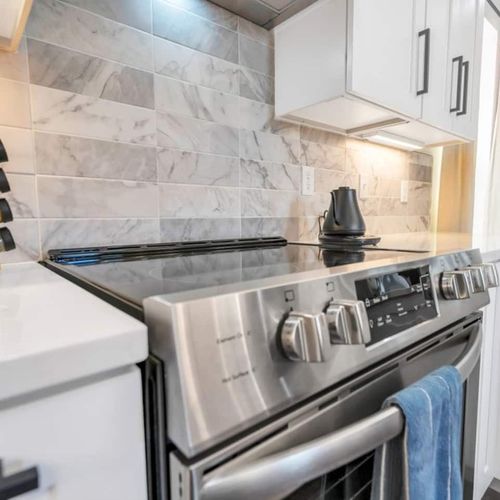 Chef-ready kitchen w/ stainless range — sleek, modern & fully equipped.
