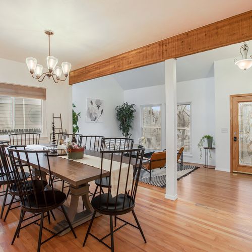 Gather with loved ones in the large dining area of this peaceful home. The elegant black dining set seats 10.