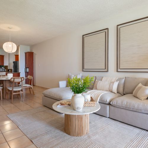 Chic coastal living meets modern comfort. Enjoy seamless flow between the inviting living room and elegant dining area.