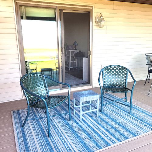 EXTERIOR:  The chairs outside the primary bedroom on the backyard patio, which faces Lake Huron