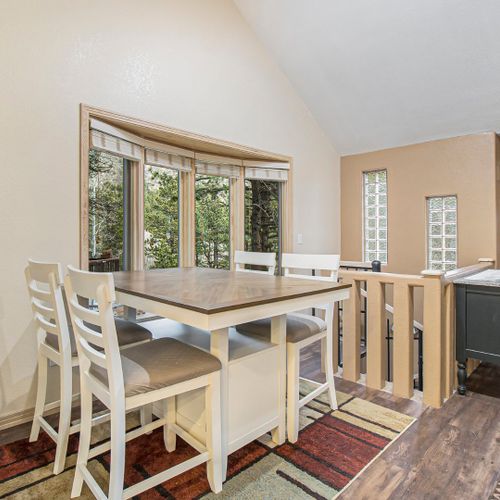 Calm and functional dining area with a wooden table, large windows, and an effortlessly peaceful vibe.