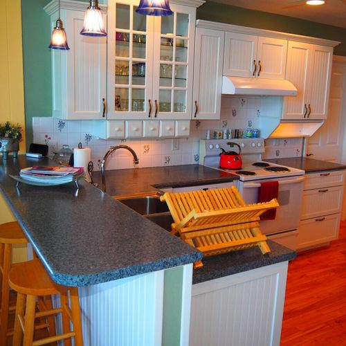 Kitchen:  the home has a large, beautiful, and very functional kitchen with all appliances including a dishwasher. There is a good supply of cooking and dining utensils included as well.