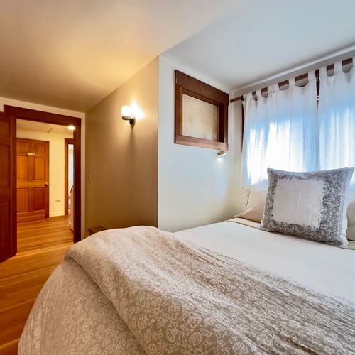 Tucked into an alcove with reading lights and windows all around.