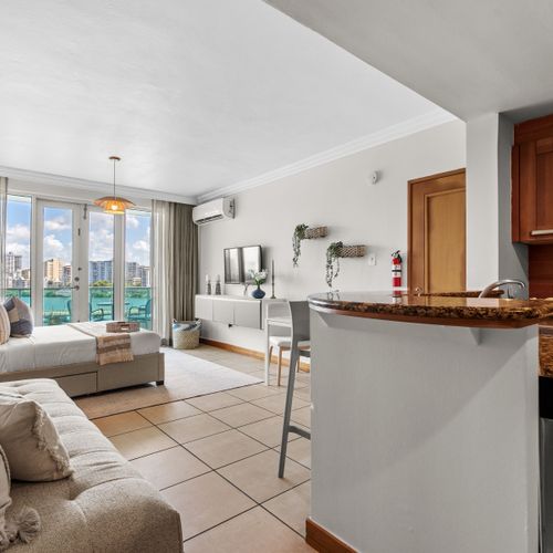 Bright living space with comfortable seating and direct balcony access. Relax and enjoy!