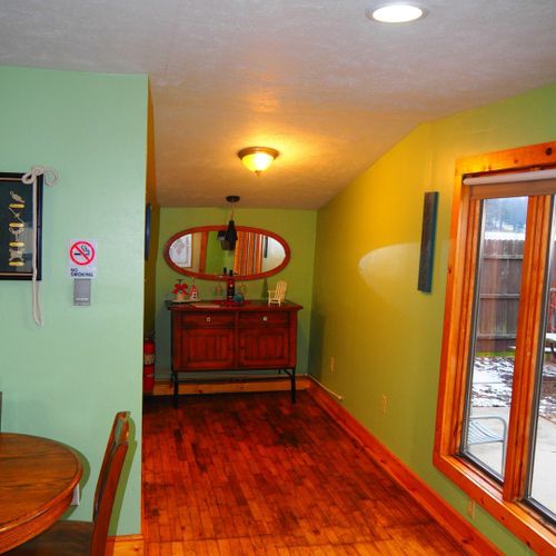 Living room and dining area:  very cute and cozy living room and dining area with a sofa, comfy chairs, dining table and chairs for 4 adults, ceiling fan, television with satellite tv, and a great view of turk lake!