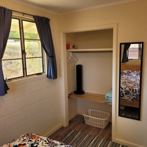Bedroom #1:  features a queen-size bed, nightstands, lamps, mirror, and closet.