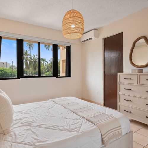 Wake up to natural light and refreshing breezes in this beautifully decorated master suite with outdoor access.