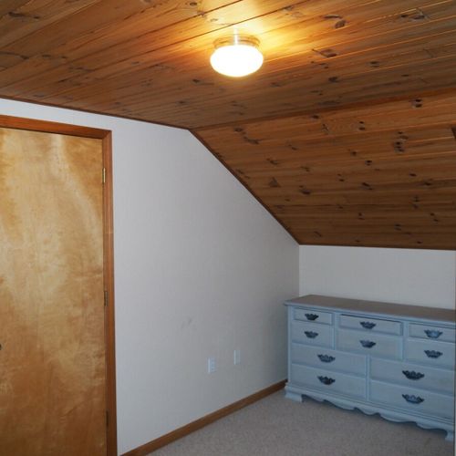 Bedroom #3 (upstairs):  features a full-size bed, dresser, and closet.
