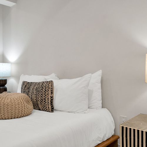 Soft textures, warm lighting & bold design details set the mood for a restful stay.