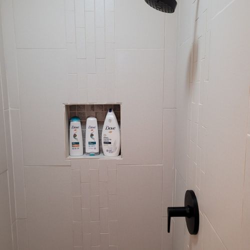 Bathroom #2:  second full bathroom that also serves as the laundry room having a stacked washer and dryer in it.