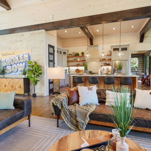 Sink into plush comfort and let the glow of the high-ceilinged living room set the tone for pure relaxation.