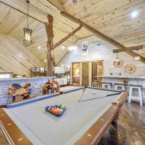 The loft doubles as a game room with a pool table, sitting areas & shuffleboard!