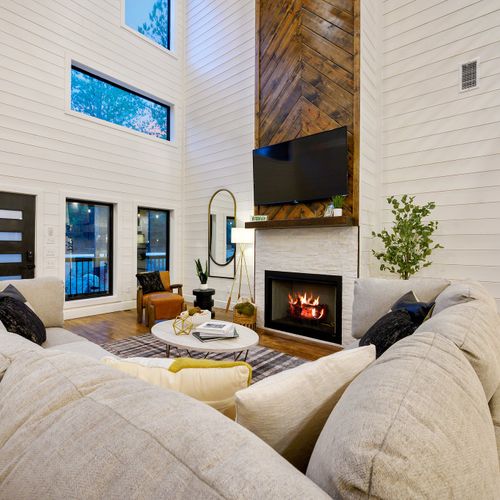 The heart of the living room is a gas fireplace and a smart TV.