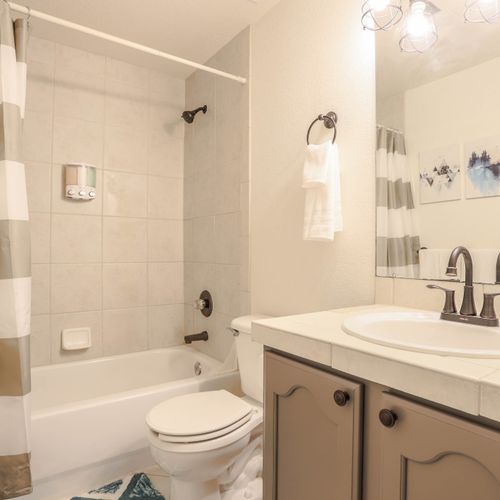 The lower level bedroom offers a private bathroom for ultimate comfort.