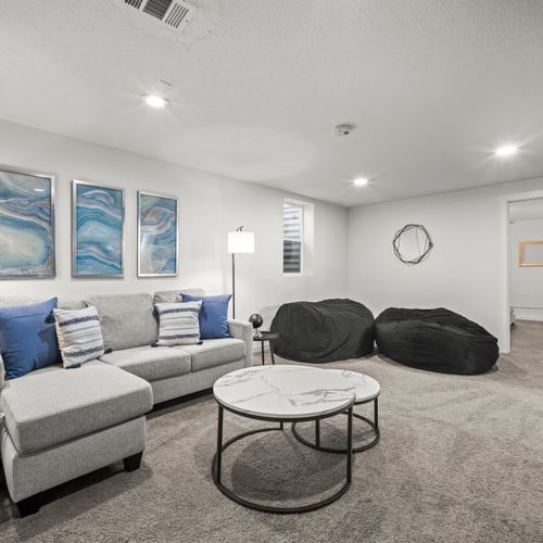 The downstairs game room includes a foosball table, extra large bean bag chairs, and tons of board games!