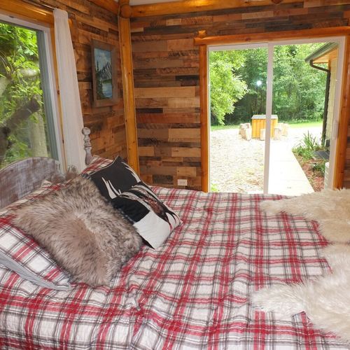 Bedroom #1:  another angle showing the sliding doors that go out to the patio. (the handmade outdoor dining table is visible outdoors. )