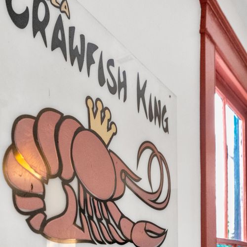 Playful nod to local culture w/ vibrant crawfish-themed wall art.