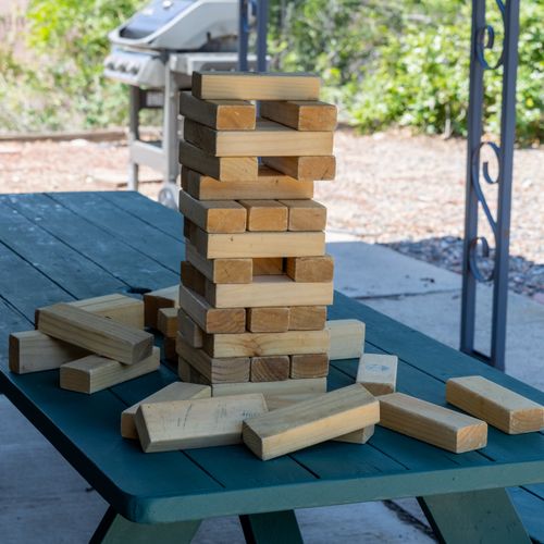 Outdoor jenga battles—who can keep the tower standing longest?