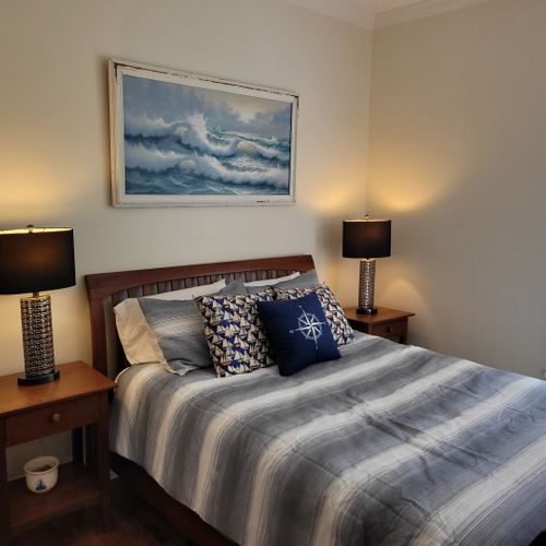 Bedroom #1 (main floor):  features a queen-size bed and its own private en suite full bathroom, dresser, nightstand, and closet.