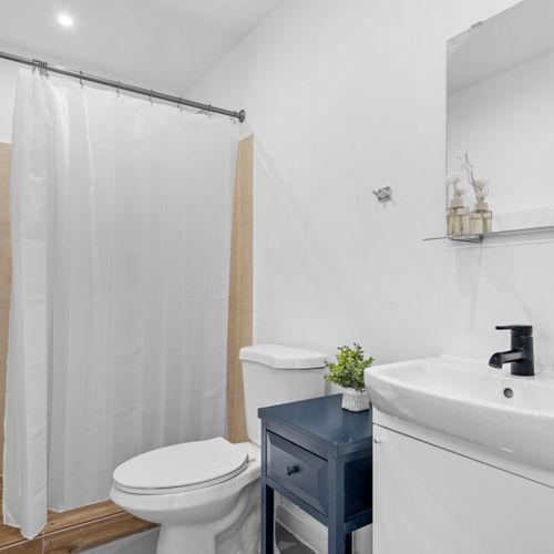 A harmonious blend of comfort and modern design awaits you in this bright, inviting bathroom space.