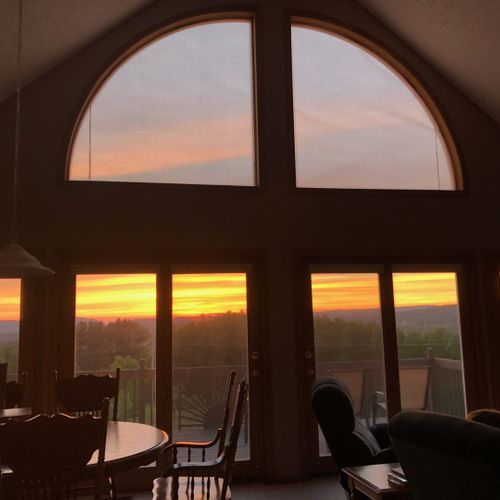 Overall:  the living room and deck with the sunset in the background