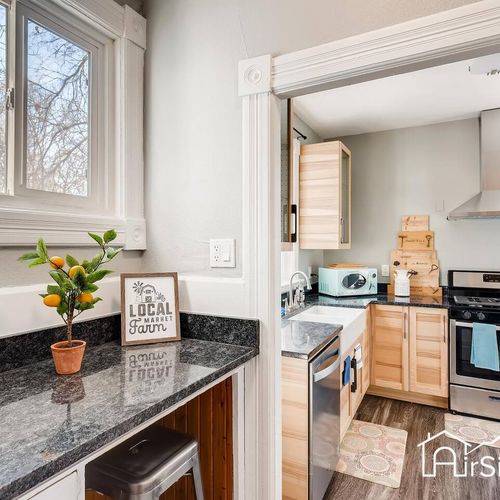 - charming breakfast nook with granite counter, stool, and a citrus plant for color
- leads directly into the main kitchen with sleek appliances and a farmhouse sink
- great spot for morning coffee or a snack break between activities