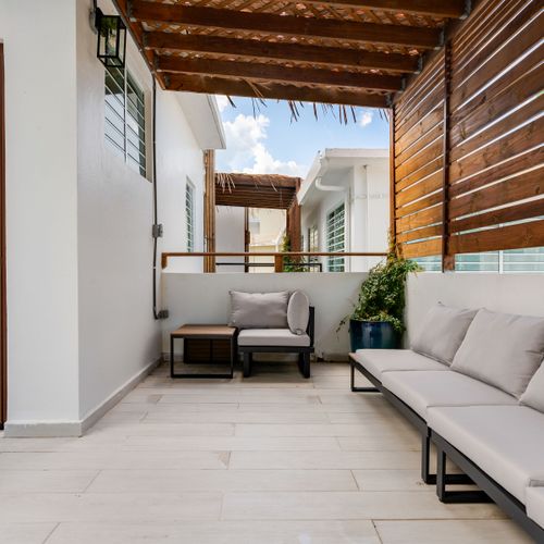 Unwind in this chic outdoor seating area, perfect for a fresh breeze.