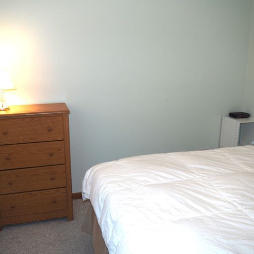 Bedroom #1 (main floor):  features a queen-size bed and a dresser.