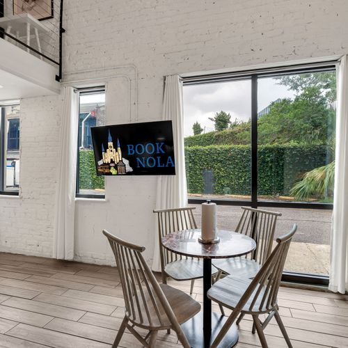 Charm meets natural radiance as the living room’s expansive windows invite the essence of New Orleans right inside (unit 2)