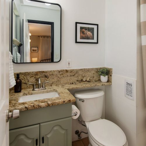 The master ensuite bath features sleek countertops, large vanity mirror and stand up shower.