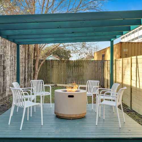 Outdoor courtyard w/ a firepit & dining set — ideal for laid-back evenings under the open sky.