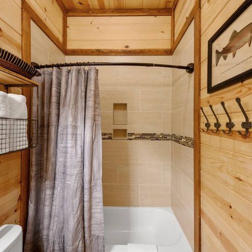 A shower/tub combo in the shared bathroom.