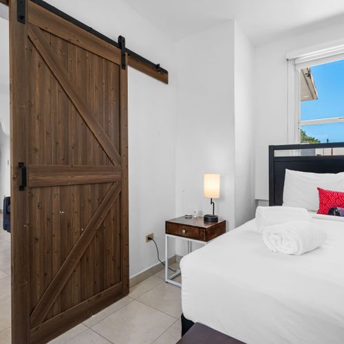 Spacious Master Bedroom with Tropical Decor.