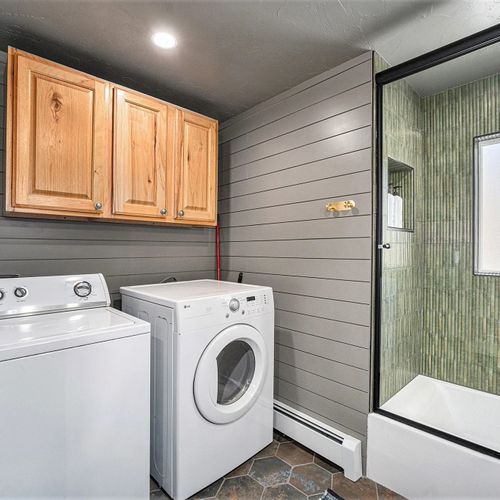 Conveniently located in the main floor bathroom, this washer and dryer setup makes laundry a breeze during your stay.