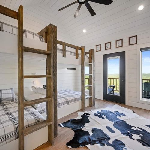 Upstairs bunkroom featuring 4 queen beds.