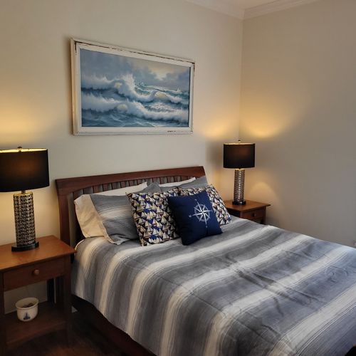 Bedroom #1 (main floor):  features a queen-size bed and its own private en suite full bathroom, dresser, nightstand, and closet.