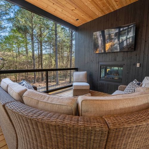Oversized outdoor couch around the fireplace!