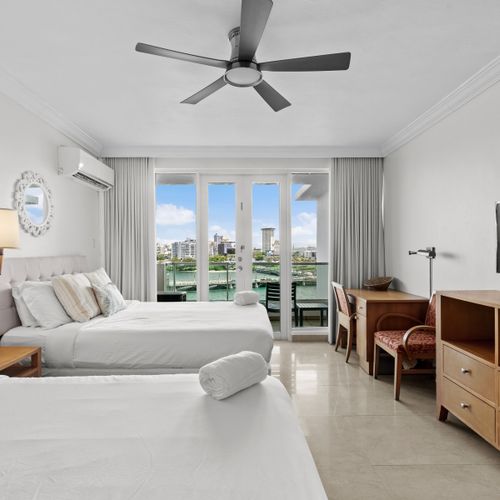 Spacious studio with two comfortable beds and direct access to a private balcony overlooking the lagoon.