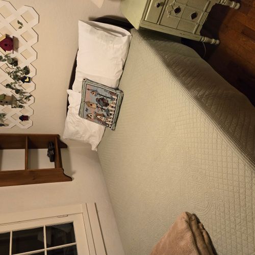 Bedroom #1:  features a full-size bed, nightstand, lamp, and dresser.