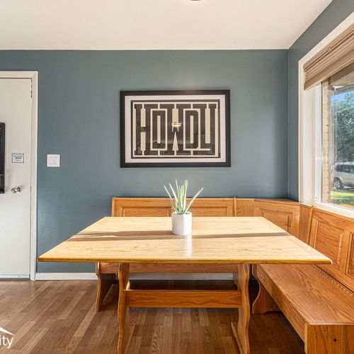 The kitchen boasts a charming banquette for additional group seating.