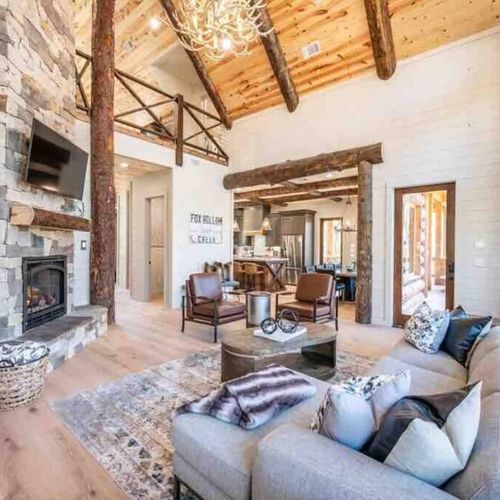 The living room has a gas fireplace, oversized sectional and chairs for lounging!