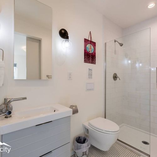- step into a sparkling walk in shower stocked with shampoo, conditioner, and body wash
- modern vanity and lighting create a polished space to freshen up anytime
- functional design and cozy details ensure a smooth start and end to your day