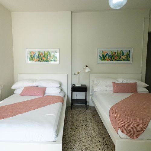 Ideal for friends or family, this room offers two comfortable twin beds, each beautifully made with fresh linens, ensuring a restful night's sleep for everyone.