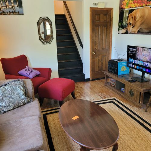 Living room:  the home has a very cozy living room with 2 sofas, a comfy chair, and a television.