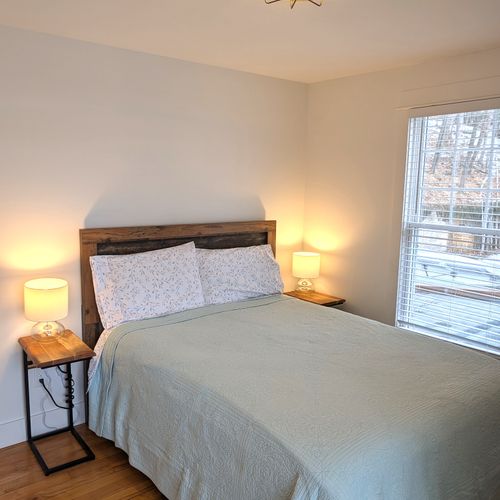 BEDROOM #2 (MAIN FLOOR):  This is a second main floor bedroom that also has a queen-size bed, nightstands, lamps, dresser, mirror, and a closet.