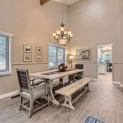 Enjoy a meal under the rustic chandelier at a table with plenty of space for 8.