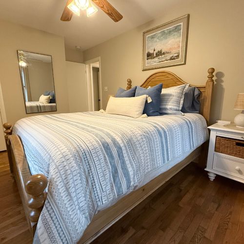 Bedroom #2:  features a queen-size bed, ceiling fan, closet, nightstands, and lamps.