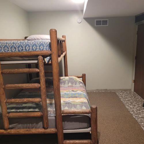Bedroom #3 (first floor):  family-friendly first floor bedroom with a twin-on-queen bunk bed, closet, and dresser.